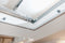 Interior view showing the Auxx Attic Lift in action, with the platform lifting items into a spacious attic storage area