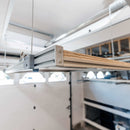 Close-up of the Auxx Attic Lift’s motorized lifting system, showcasing the durable cables and motor unit in action