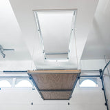 Wide-angle shot of the Auxx Attic Lift installed in a spacious garage, ready to transport items to an attic storage area