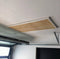 View from below the Auxx Attic Lift platform, highlighting the lift's motorized cable system