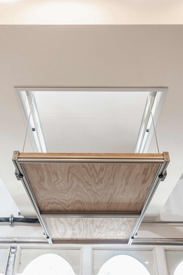 View of the Auxx Attic Lift system installed in a home, showcasing its robust lifting platform in a residential attic