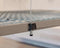 Close-up of the Auxx Lift's wireless remote control, highlighting its ergonomic design and user-friendly interface