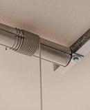 Side view of the Auxx Lift installed in a garage, showcasing its compact design and efficient use of overhead space