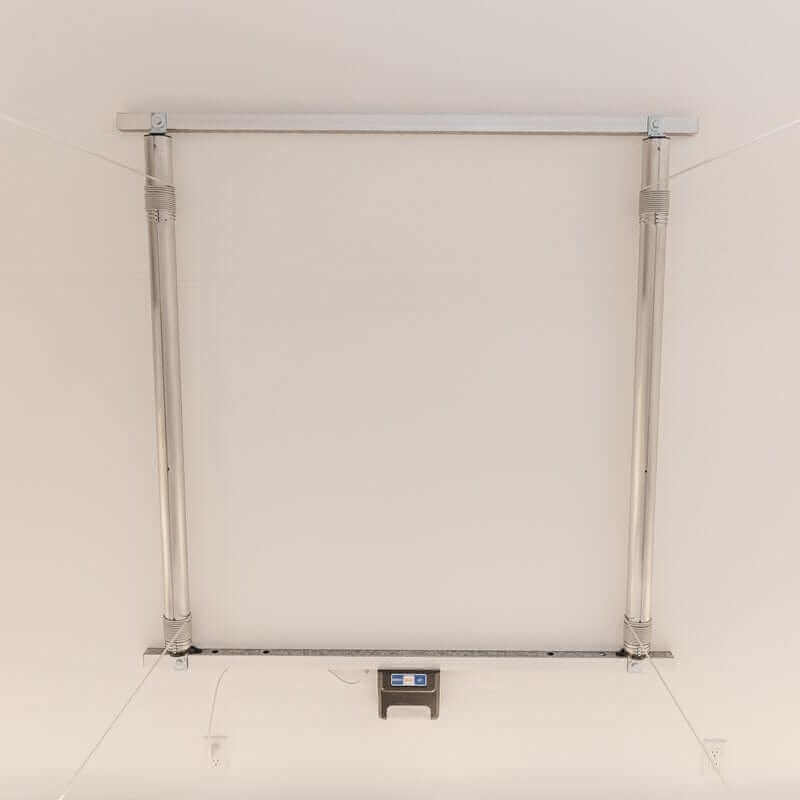 Wide-angle view of the Auxx Lift in a garage setting, illustrating its capacity to store large items overhead