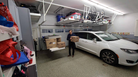 Wide garage view featuring the Auxx Lift fully loaded with items, demonstrating vertical storage efficiency