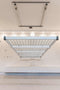 Front view of the Auxx Lift Platform Storage Lift installed in a garage, holding multiple storage bins